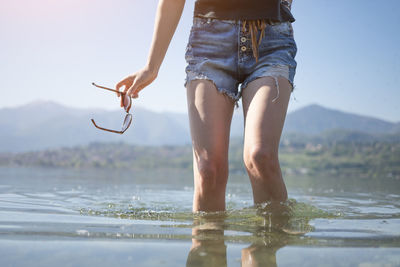 Low section of woman in water