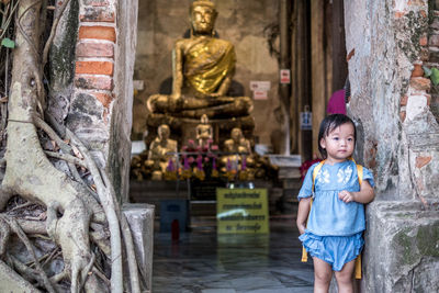 Full length of boy statue against temple outside building