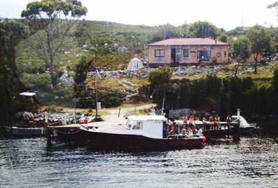 Boats in river with buildings in background