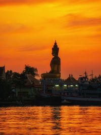 Scenic view of river against orange sky