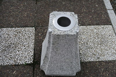 High angle view of bollard on cobblestone street