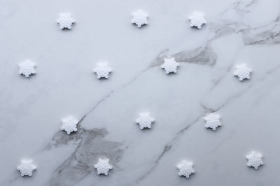 High angle view of snowflake shaped candies on table