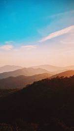 Scenic view of silhouette mountains against sky during sunset