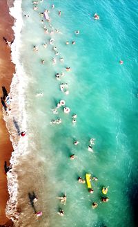 High angle view of people swimming in sea