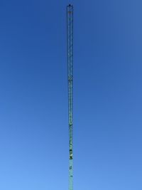 Low angle view of power lines against clear blue sky