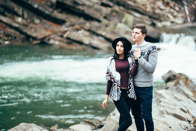 Young couple standing in water