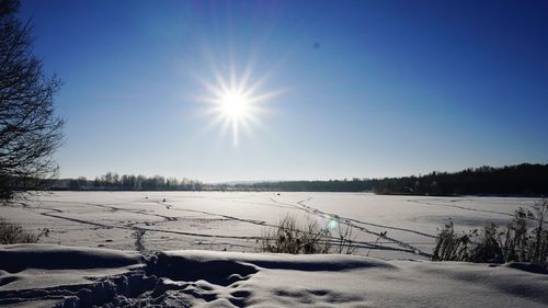Scenic view of snow covered field against clear sky