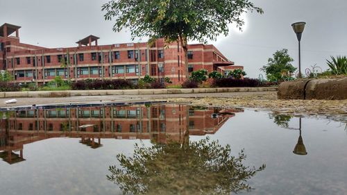 Reflection of buildings in lake against sky