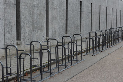 Footpath by railing against wall