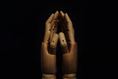 Close-up of human hand against black background