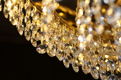 Close-up of illuminated lighting equipment against black background