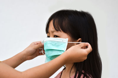 Asian little girl wear a medical mask to avoid contagious viruses. stop the outbreak coronavirus.