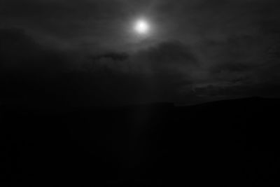 Low angle view of silhouette moon against sky at night