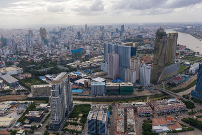 High angle view of modern buildings in city against sky