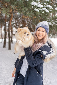 Portrait of smiling woman in snow