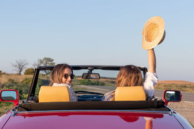 Rear view of woman holding car