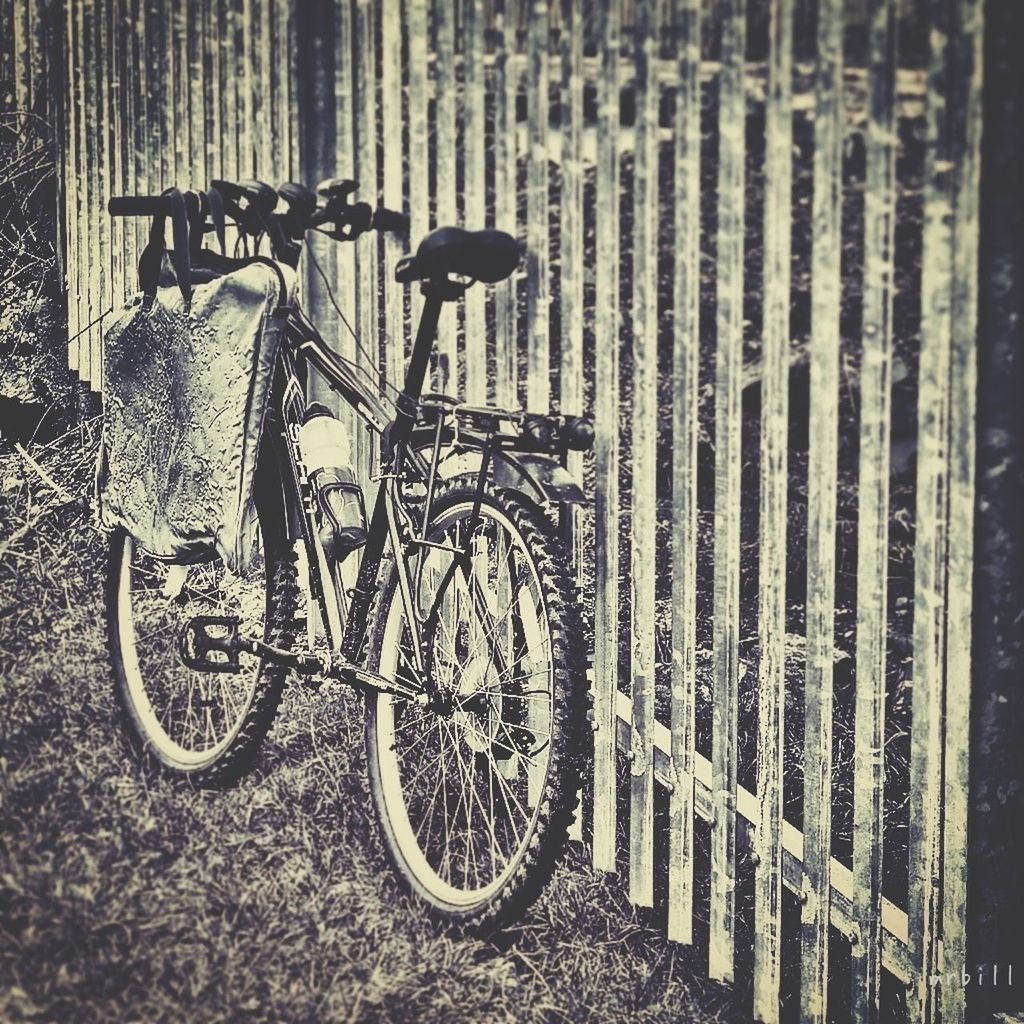 bicycle, transportation, mode of transport, land vehicle, railing, parked, stationary, built structure, wall - building feature, architecture, day, parking, street, outdoors, metal, no people, wheel, road, the way forward, high angle view