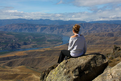 Rear view of woman standing on mountain