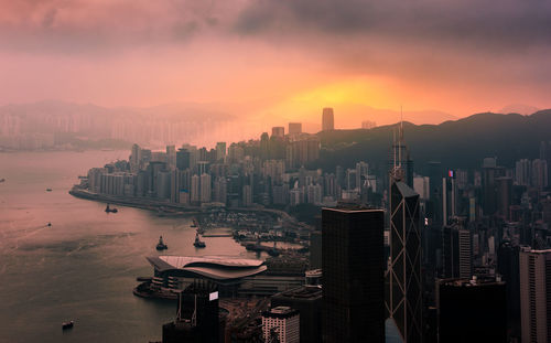 Panoramic view of city by sea against sky