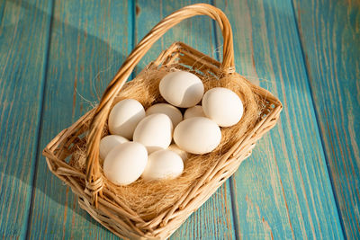 High angle view of eggs in basket on table