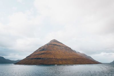 View of volcanic landscape against cloudy sky