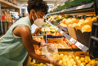 Midsection of man standing at market stall