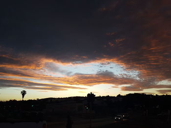 Silhouette buildings against sky during sunset