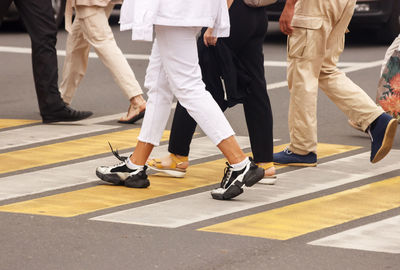 Low section of people walking on road
