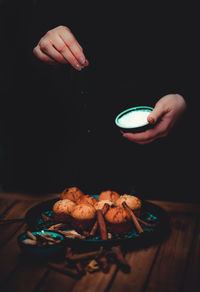 Close-up of hand holding ice cream on table