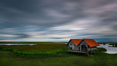 House on field against sky