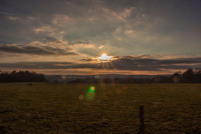 Scenic view of field against sky during sunset