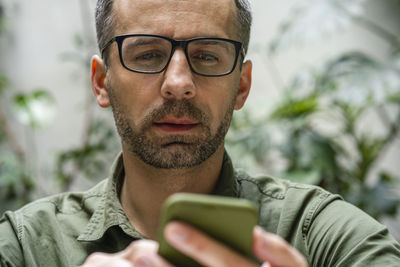 Portrait of young man using smart phone outdoors
