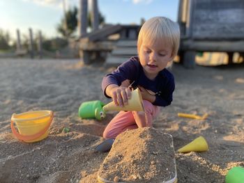 Side view of baby playing with straw