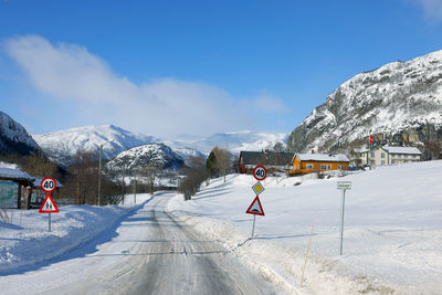 Rear view of man walking on snow covered mountain