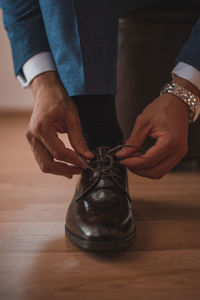 Low section of man holding wooden table