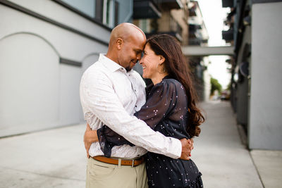 Midsection of couple standing outdoors