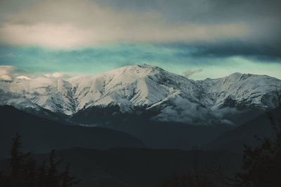 Scenic view of snowcapped mountains against sky