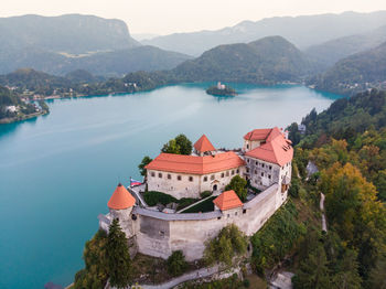 High angle view of lake and buildings against sky