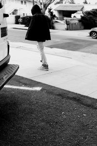 Low section of woman walking on road