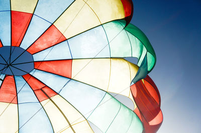 Low angle view of hot air balloon against clear blue sky