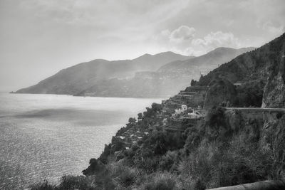 Scenic view of sea and mountains against sky