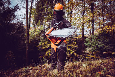 Rear view of man standing in forest