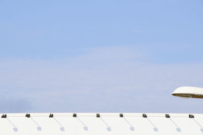 Low angle view of power lines against blue sky