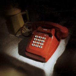 Close-up of telephone booth on table