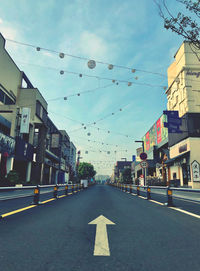 Street amidst buildings against sky in city