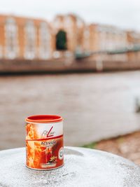 Close-up of coffee cup against wall