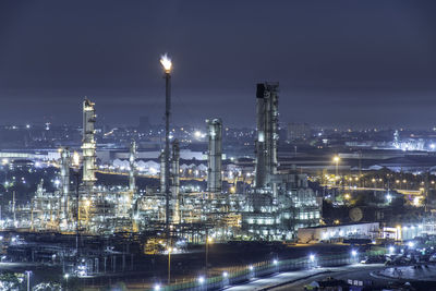 High angle view of illuminated city against sky at night