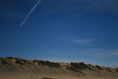 Low angle view of vapor trails in sky