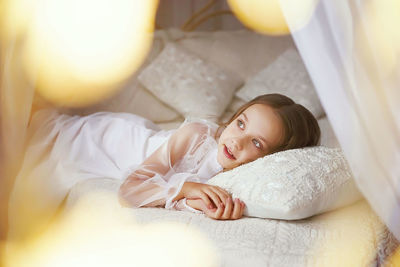 Girl lying on bed at home