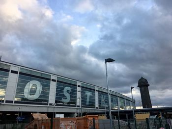 Low angle view of text on bridge against sky